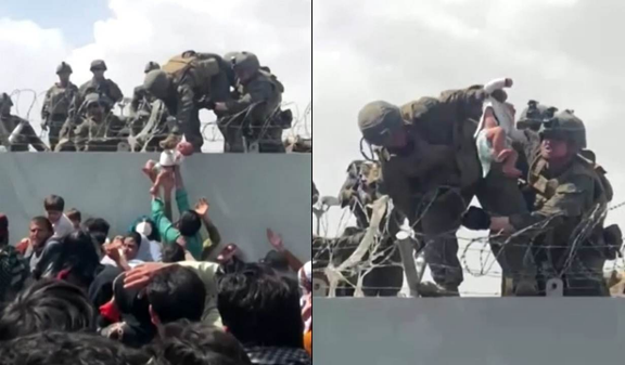 Afegãos passam bebê por arame farpado para soldados americanos